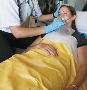 Paitient in ambulance covered in an emergency blanket